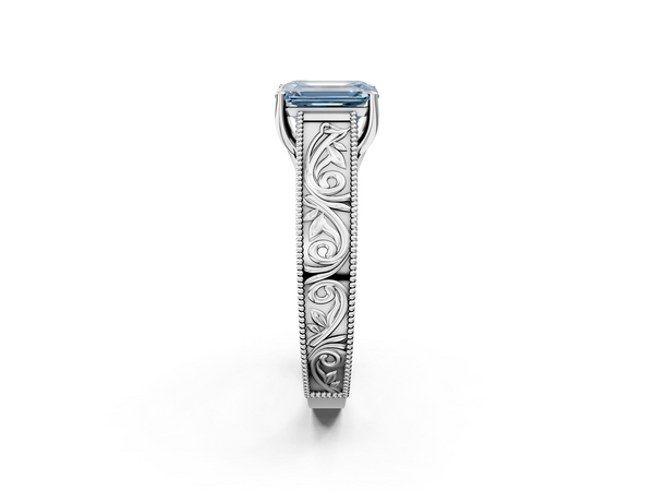 White gold Fancy Blue Emerald Cut Diamond Solitaire Ring with Engraved Band and Four-Prong Setting