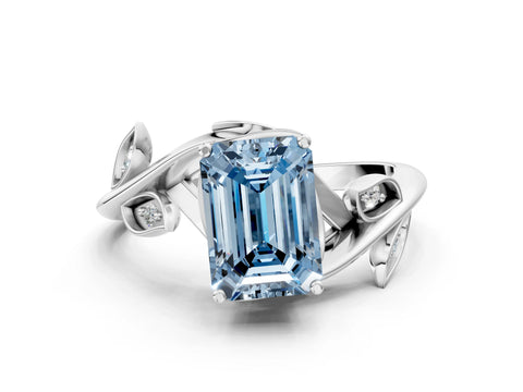 White gold Fancy Blue Emerald Cut Solitaire Twist Engagement Ring with Leaf Accents and Prong Setting