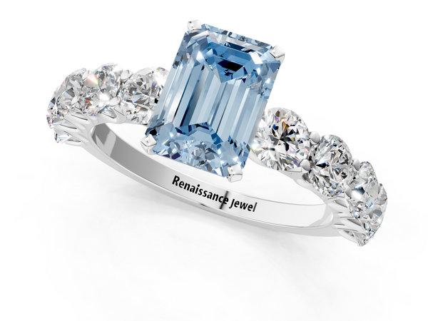 White gold Fancy Blue Emerald Cut Diamond Prong Setting with Side Stones on a Pave Band
