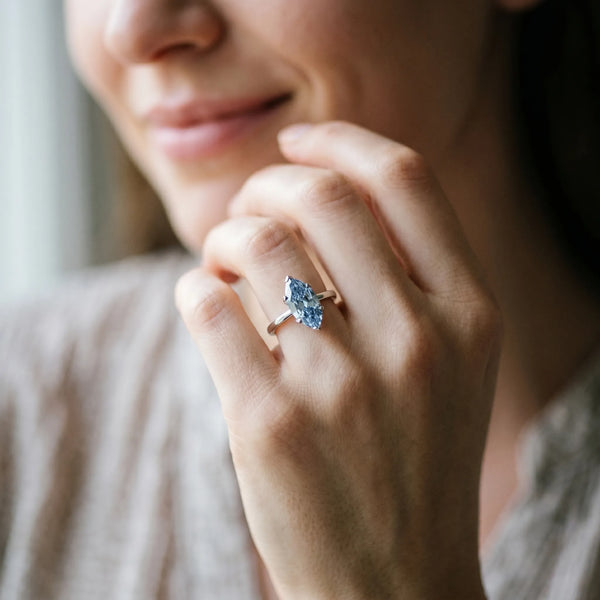 Platinum Fancy Blue Marquise Cut Diamond Solitaire Ring with Flower Prong Setting and Classic Band