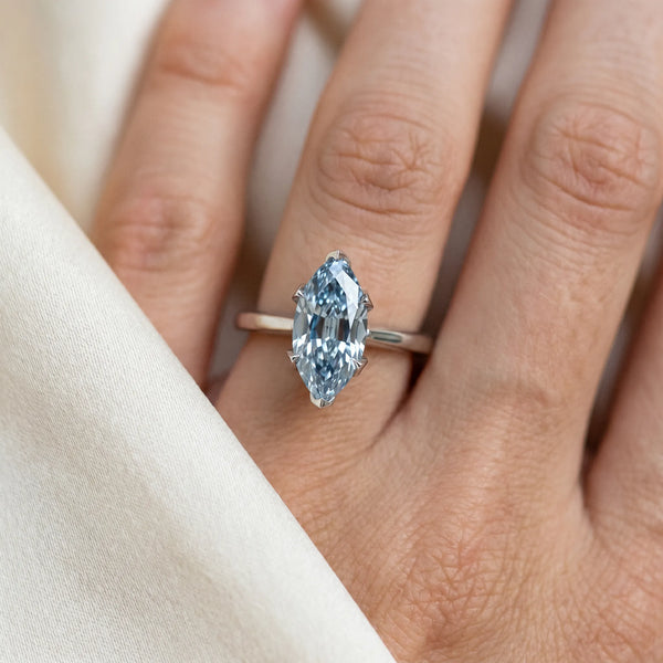 Platinum Fancy Blue Marquise Cut Diamond Solitaire Ring with Flower Prong Setting and Classic Band