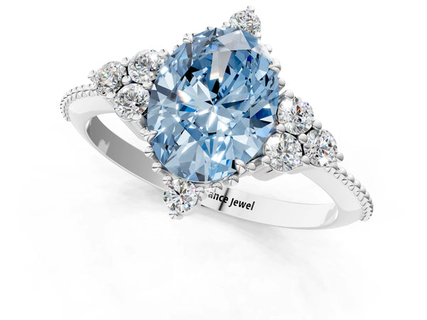 White gold Fancy Blue Oval Cut Brilliant Diamond with Cluster Setting on a Beaded Band and Four-Prong Setting