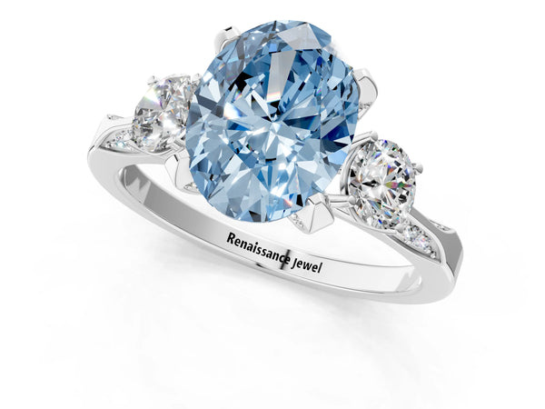 White gold Fancy Blue Oval Cut Brilliant Three-Stone Diamond Ring with Pavé Band and Four-Prong Setting