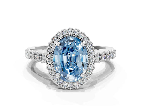 White gold Fancy Blue Oval Cut Cut Halo Pavé Solitaire Ring with Milgrain Band