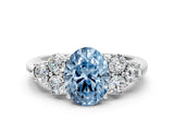 White gold Fancy Blue Oval  Cut Diamond Cluster Ring with Round Accent Stones and Prong Setting on a Classic Band_49