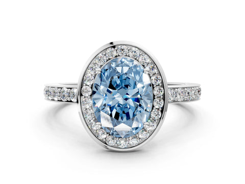 White gold Fancy Blue Oval Cut Diamond Halo Ring with Bezel Frame and Pavé Band