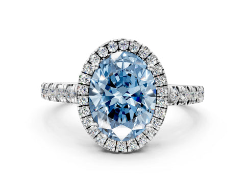White gold Fancy Blue Oval Cut Diamond Halo Ring with Pavé Band and Four-Prong Setting
