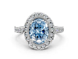 White gold Fancy Blue Oval Cut Diamond Halo Ring with Pavé Band and Prong Setting