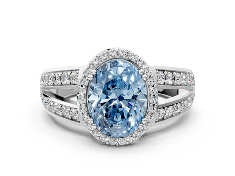White gold Fancy Blue Oval Cut Diamond Halo Ring with Split Shank Pavé Band and Four-Prong Setting