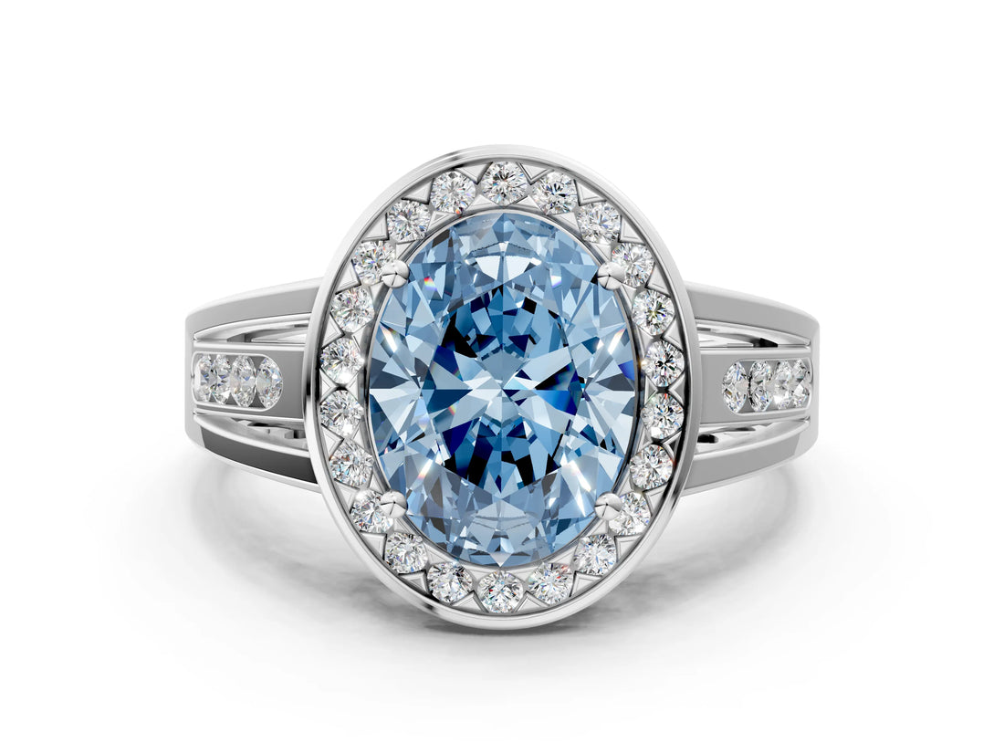 White gold Fancy Blue Oval Cut Diamond Halo Ring with Split Shank and Bezel Accents and Prong Setting