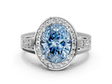 White gold Fancy Blue Oval Cut Diamond Halo Ring with Split Shank and Bezel Accents and Prong Setting