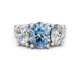 White gold Fancy Blue Oval Cut Diamond Three-Stone Ring with Channel Set Band and Four-Prong Setting_60