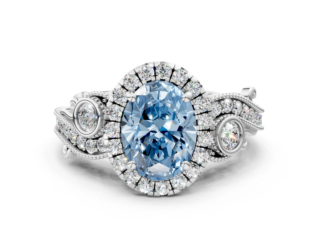 White gold Fancy Blue Oval Cut Halo Diamond Ring with Milgrain and Bezel Accents on a Split Shank Band