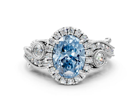 White gold Fancy Blue Oval Cut Halo Diamond Ring with Milgrain and Bezel Accents on a Split Shank Band