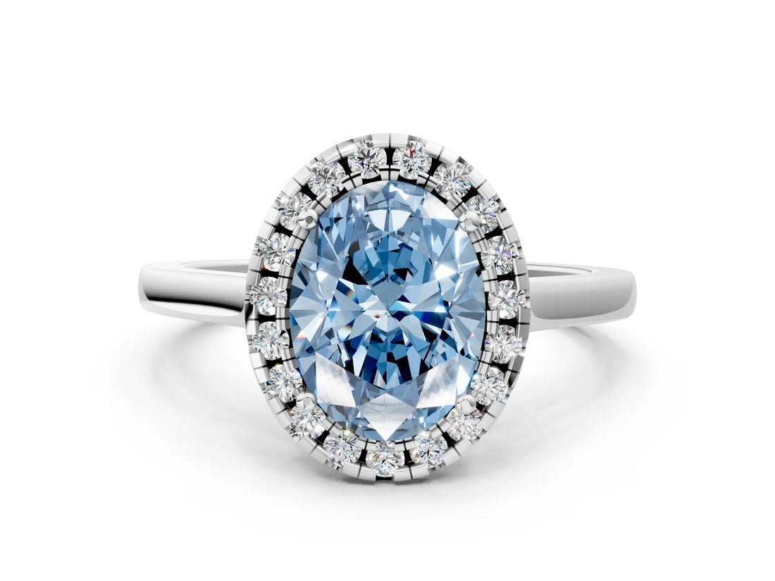 White gold Fancy Blue Oval Cut Halo Round Diamond Solitaire Ring with Pavé Band and Four-Prong Setting