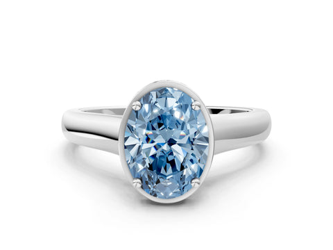 White gold Fancy Blue Oval Cut Solitaire Diamond Engagement Ring with Four-Prong Setting and Tapered Band