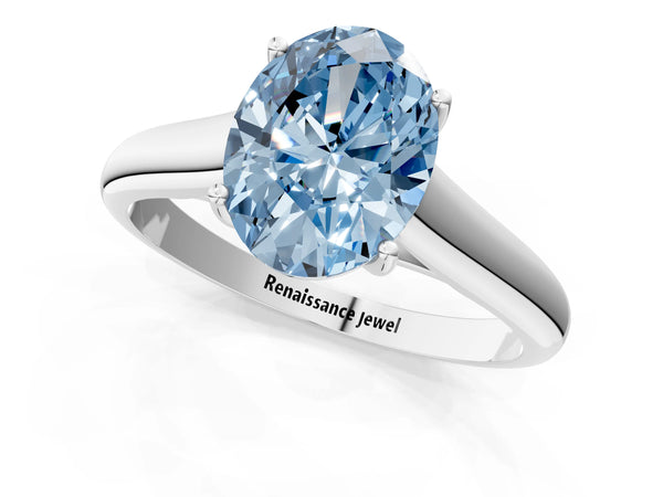 White gold Fancy Blue Oval Cut Solitaire Engagement Ring with Tapered Band and Four-Prong Setting