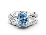 White gold Fancy Blue Oval Cut Solitaire Leaf-Inspired Engagement Ring with Prong Setting