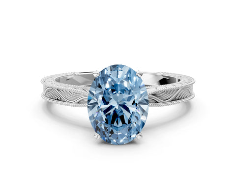 White gold Fancy Blue Oval Cut Solitaire Milgrain Engraved Band with Four-Prong Setting