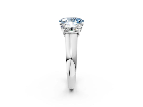White gold Fancy Blue Oval Cut Three-Stone Diamond Ring with Prong Setting on a Classic Band