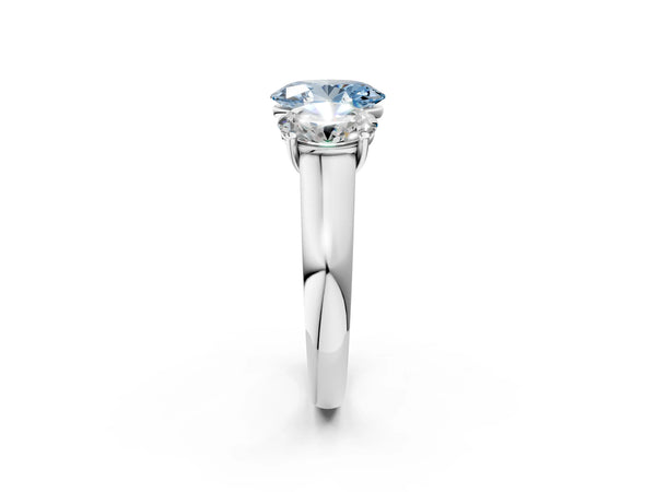White gold Fancy Blue Oval Cut Three-Stone Diamond Ring with Prong Setting on a Classic Band