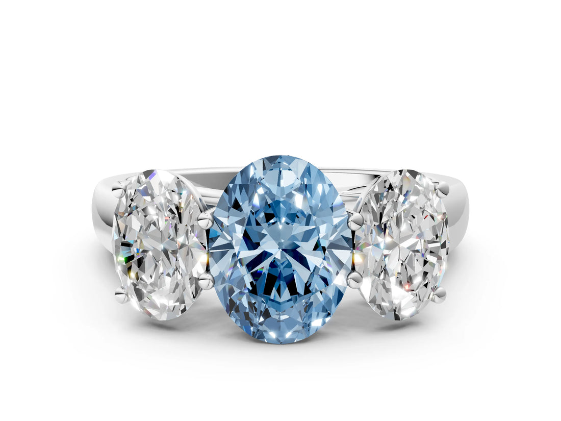 White gold Fancy Blue Oval Cut Three-Stone Diamond Ring with Prong Setting on a Classic Band
