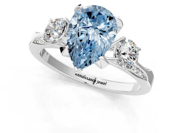 White gold Fancy Blue Pear Cut Brilliant Three-Stone Diamond Ring with Pavé Band and Four-Prong Setting