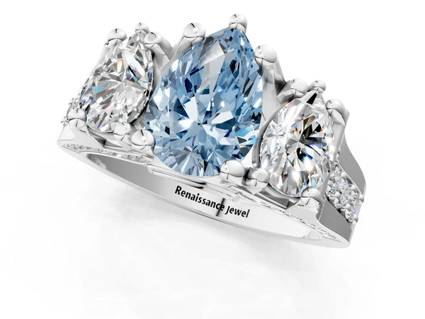 White gold Fancy Blue Pear Cut Diamond Three-Stone Ring with Channel Set Band and Four-Prong Setting