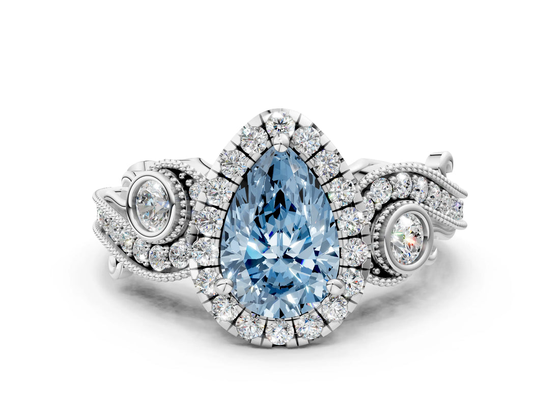 White gold Fancy Blue Pear Cut Halo Diamond Ring with Milgrain and Bezel Accents on a Split Shank Band