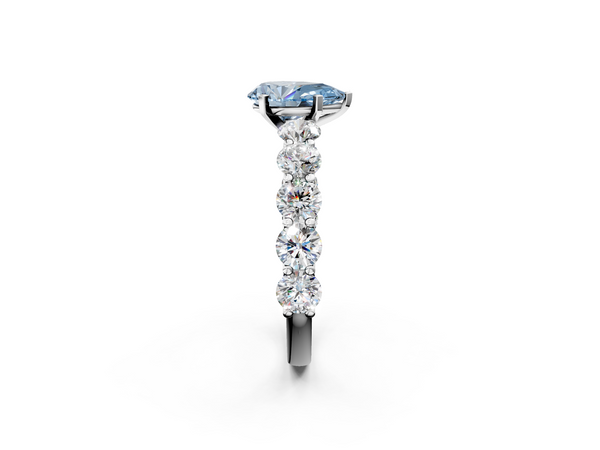 White gold Fancy Blue Pear Cut Diamond Prong Setting with Side Stones on a Pave Band
