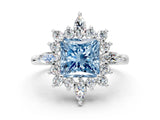 White gold Fancy Blue Princess Cut Halo Diamond Cluster Ring with Marquise and Round Stones on a White Gold Band with Prong Setting