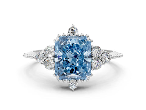 White gold Fancy Blue Radiant Cut Brilliant Diamond with Cluster Setting on a Beaded Band and Four-Prong Setting