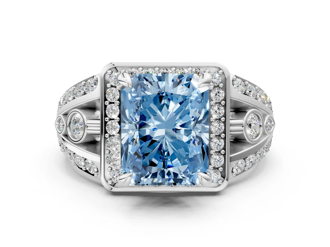 White gold Fancy Blue Radiant Cut Diamond Halo Ring with Split Shank and Bezel Accents and Four-Prong Setting