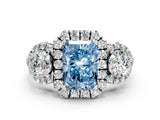 White gold Fancy Blue Radiant Cut Diamond Three-Stone Halo Ring with Prong Setting and Pavé Accents