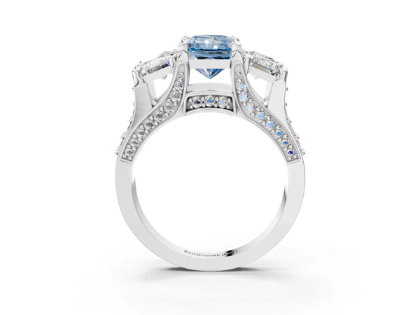 White gold Fancy Blue Radiant Cut Diamond Three-Stone Ring with Channel Set Band and Four-Prong Setting