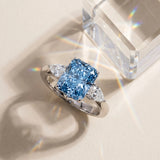 White gold Fancy Blue Radiant Cut Diamond Three-Stone Ring with Pear  Side Stones and Prong Setting_148