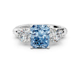 White gold Fancy Blue Radiant Cut Diamond Three-Stone Ring with Prong Setting and Pavé Band