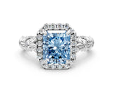 White gold Fancy Blue Radiant Cut Halo Diamond Solitaire with Filigree Band and Four-Prong Setting