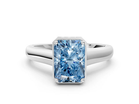 White gold Fancy Blue Radiant Cut Solitaire Diamond Engagement Ring with Four-Prong Setting and Tapered Band