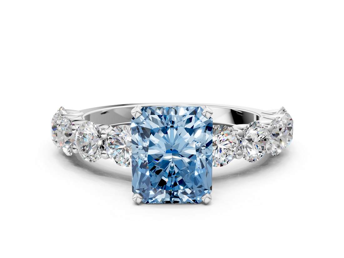 Platinum 5.60 Carat Blue VVS2 Radiant Diamond Prong Setting with Side Stones on a Pave Band
