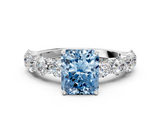 Platinum 5.60 Carat Blue VVS2 Radiant Diamond Prong Setting with Side Stones on a Pave Band