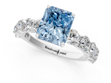Platinum 5.60 Carat Blue VVS2 Radiant Diamond Prong Setting with Side Stones on a Pave Band