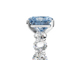 Platinum 5.60 Carat Blue VVS2 Radiant Diamond Prong Setting with Side Stones on a Pave Band