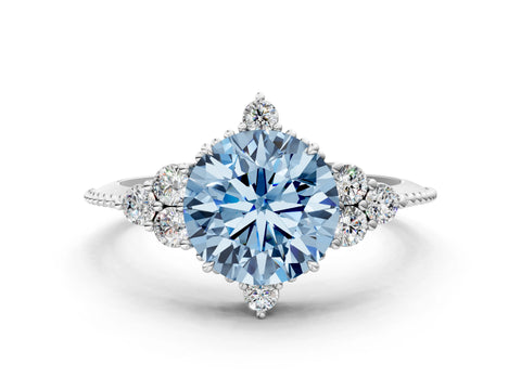 White gold Fancy Blue Round Cut Brilliant Diamond with Cluster Setting on a Beaded Band and Four-Prong Setting