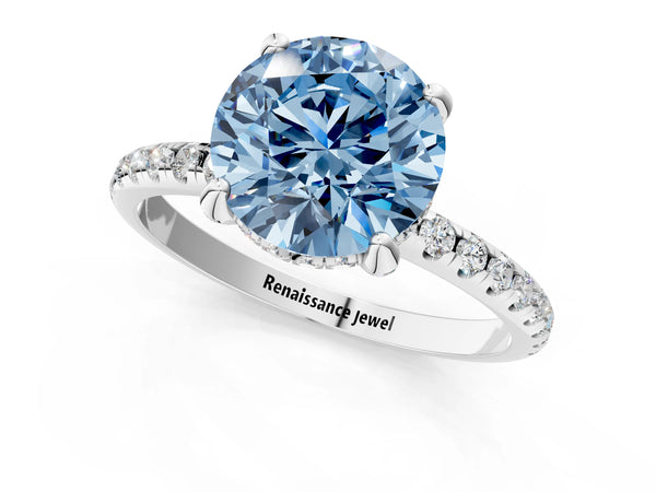 White gold Fancy Blue Round Cut Diamond Solitaire Ring with Four-Prong Setting and Pavé Band