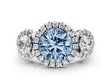White gold Fancy Blue Round Cut Diamond Three-Stone Halo Ring with Prong Setting and Pavé Accents