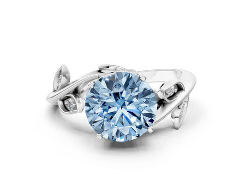 White gold Fancy Blue Round Cut Solitaire Twist Engagement Ring with Leaf Accents and Prong Setting