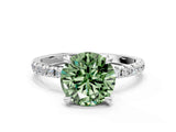 White gold Fancy Green Round Cut Diamond Brilliant Solitaire Ring with Pavé Band and Four-Prong Setting