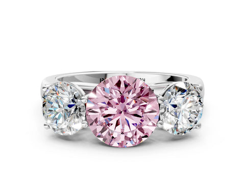 White gold Fancy Pink Round Cut Three-Stone Diamond Ring with Prong Setting on a Classic Band