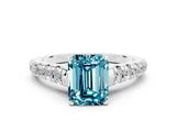 White gold Fancy White Emerald Cut Blue Topaz Solitaire Ring with Cathedral Setting and Pavé Band